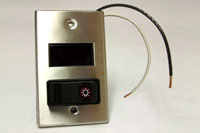 metal and black plastic digital thermometer and light switch with two wires coming out of it
