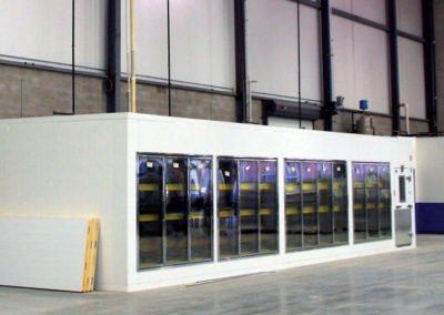 a white cooler with glass doors in a large room